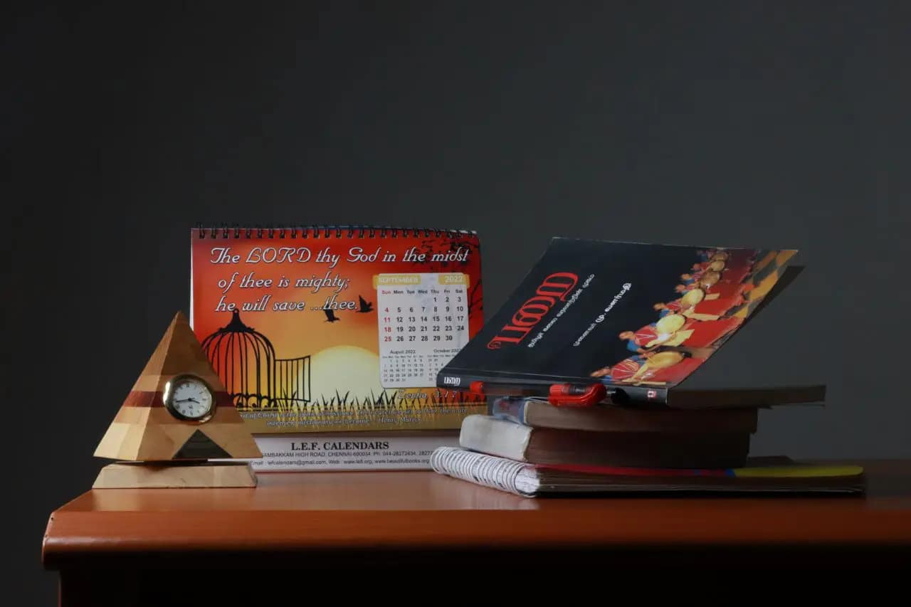 A still-life arrangement of stacked and open books